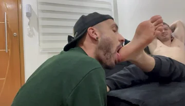 Latino boy licking masters feet
