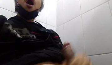 Man Sits in the Bathroom