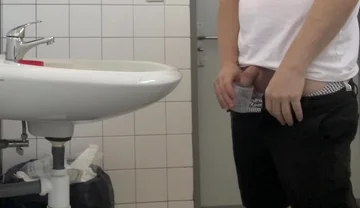 Guy Taking a Urine Sample in Hospital Toilets