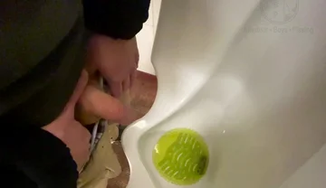Amateur Redhead Guy Caught Pissing in a Public Toilet's Urinal - He Then Quickly Plays with His Cock Before Leaving