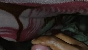 Big Boss massaging penis oil under the blanket