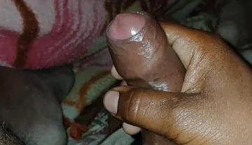 Big Boss massaging penis oil under the blanket