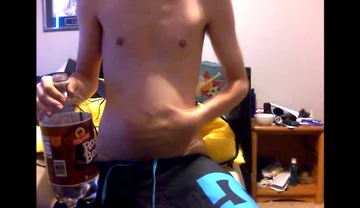 Young Guy Fills His Stomach with Water