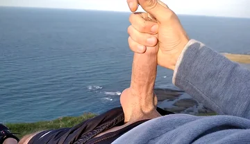 Huge Dirty Cock Gets Handjob on the Beach and Squirts a Lot of Thick Sperm in Front of the Beach