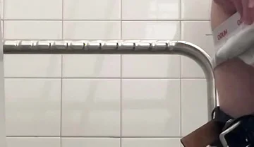 In the Hospital Toilets, a Guy Pisses Into a Cup for a Urine Sample, Then Gets Horny, Jerks-off and Cums