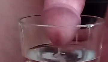 Cumming in a glass of hot water