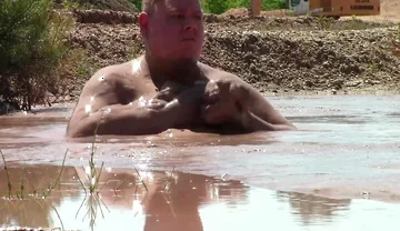 Deep, Creamy Brown Mud Bath in a Sand Pit