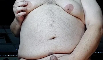 Chubby Guy Stands and Cums
