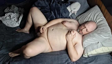 Chubby Guy Lays in Bed and Cums