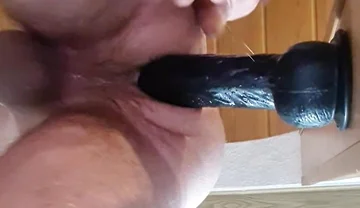 Stepdaddy Fucks Herself in the Ass with a Big Thick Black Dildo in the Door Frame and Cums.