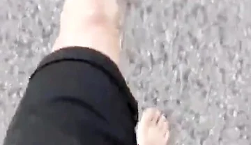 Jon Arteen Walks Barefoot on the Street Outdoors, the Boy Is Barefoot in the Crowded Tram to the Town Center