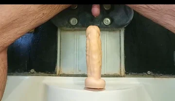 Mulatto Jumps on a Dildo and Pisses