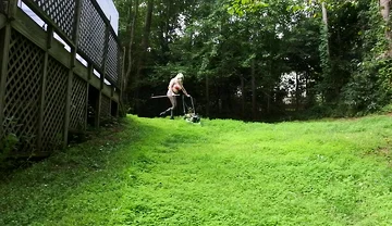 Big Fake Tits Crossdresser in Daisy Dukes Mowing Grass