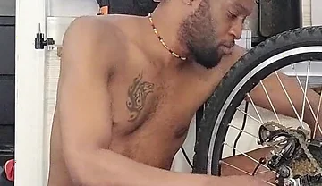 Kennie Jai Does a Nude Bike Repair. Watch That Big Dick Swing!