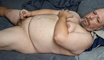 Chubby Guy Lays in Bed and Cums