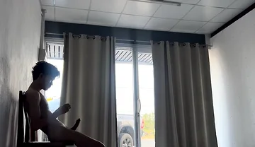 A Handsome Young Man Jerks off in Front of a Glass Door