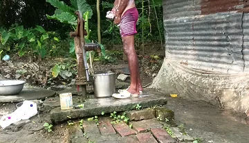 Black mature man bath in desi style. Showing big dick.