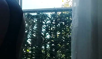 In Lingerie and Heels at the Window with a Toy