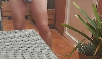 In a Thong on the Terrace with Anal Plug